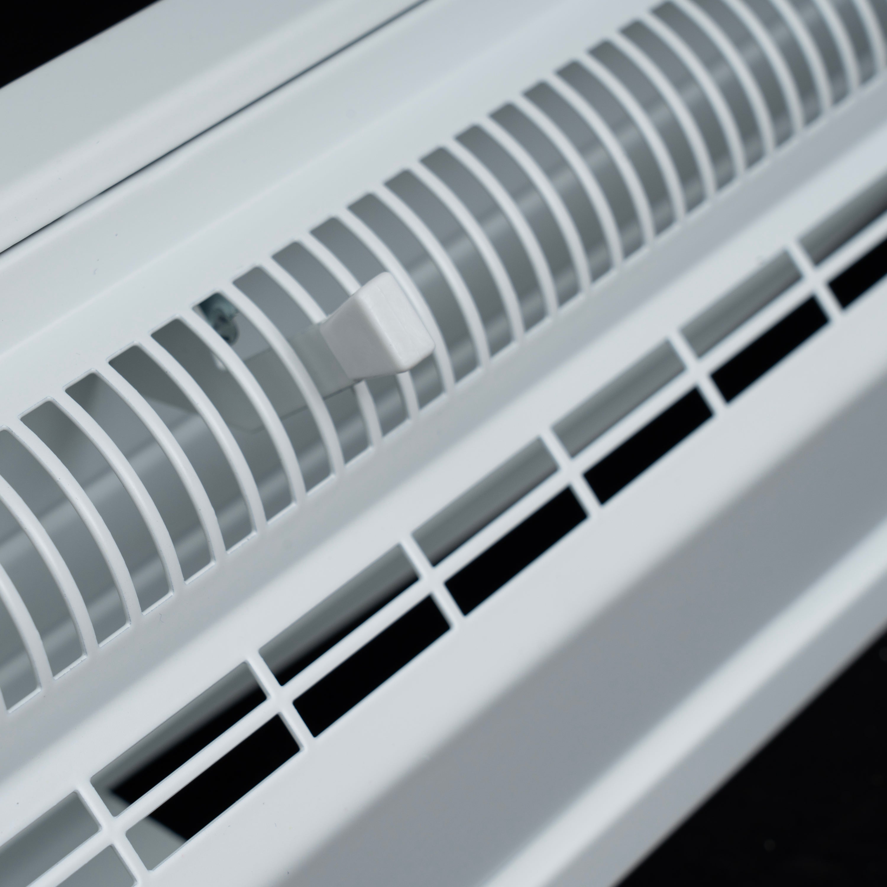 48" White Steel corner baseboard supply register, damper lever detail